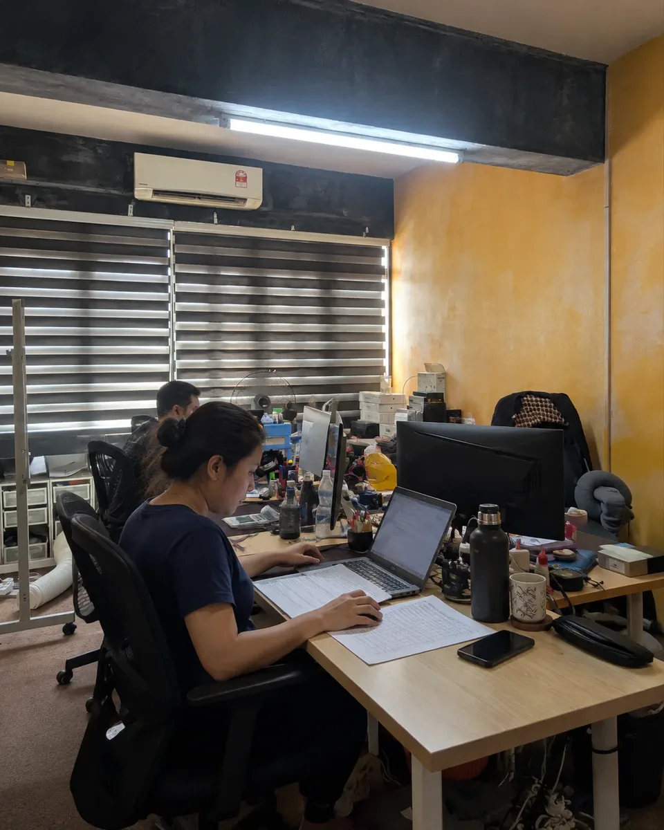 An operations lead working at a desk beside the floor