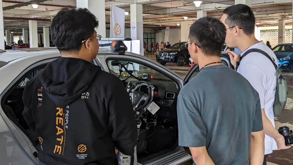 REKA archive. Actual people around the REKA test vehicle at Malaysia Autoshow 2023, a distinct capture from all photographs already allocated.